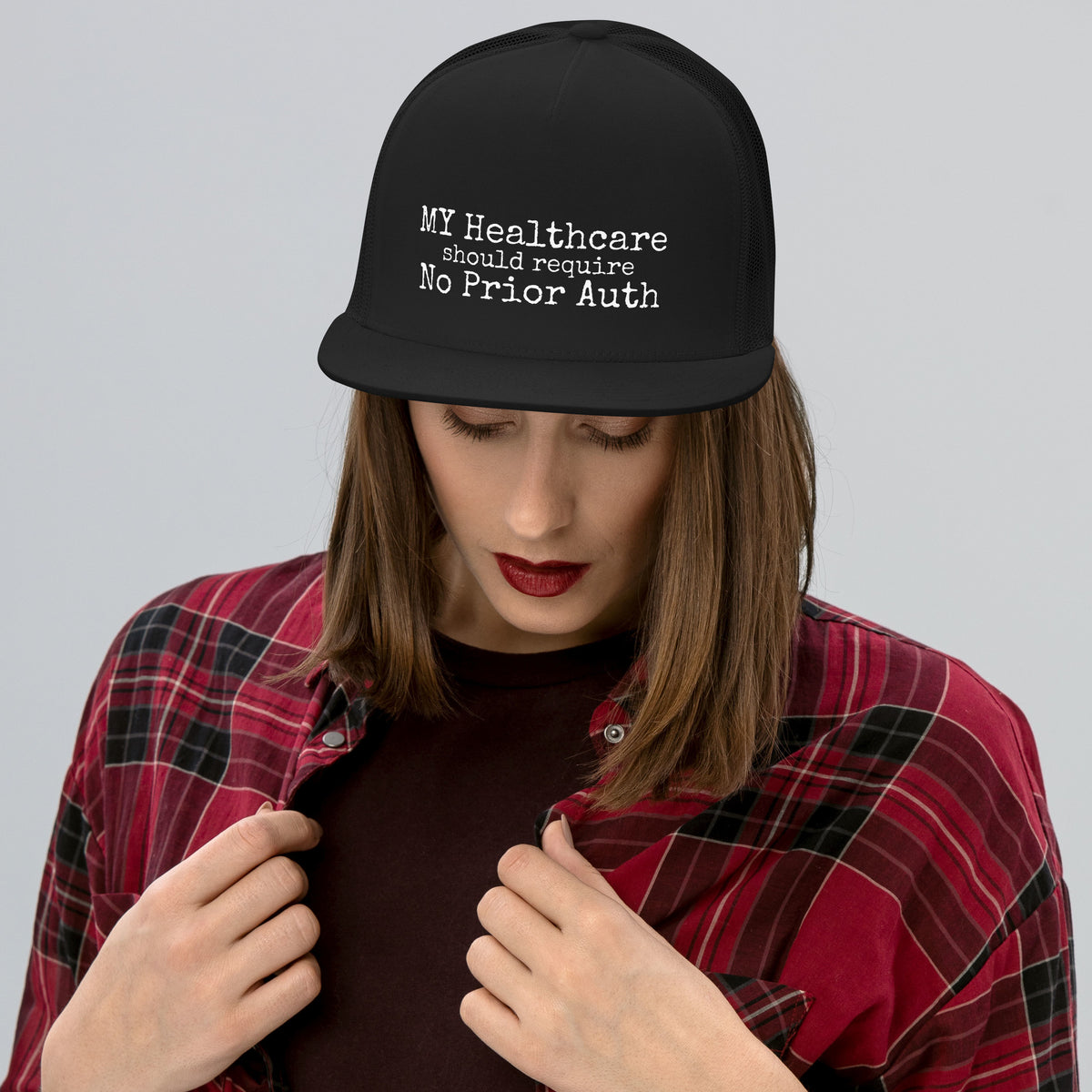 THE OVERHEAD PAGE Trucker Cap in black, flat bill trucker hat for healthcare workers, front view, physician owned