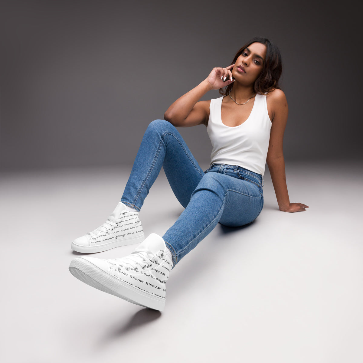 NO PRIOR AUTH High Tops, white canvas high top sneakers with repeating No Prior Auth print, worn with jeans, physician owned